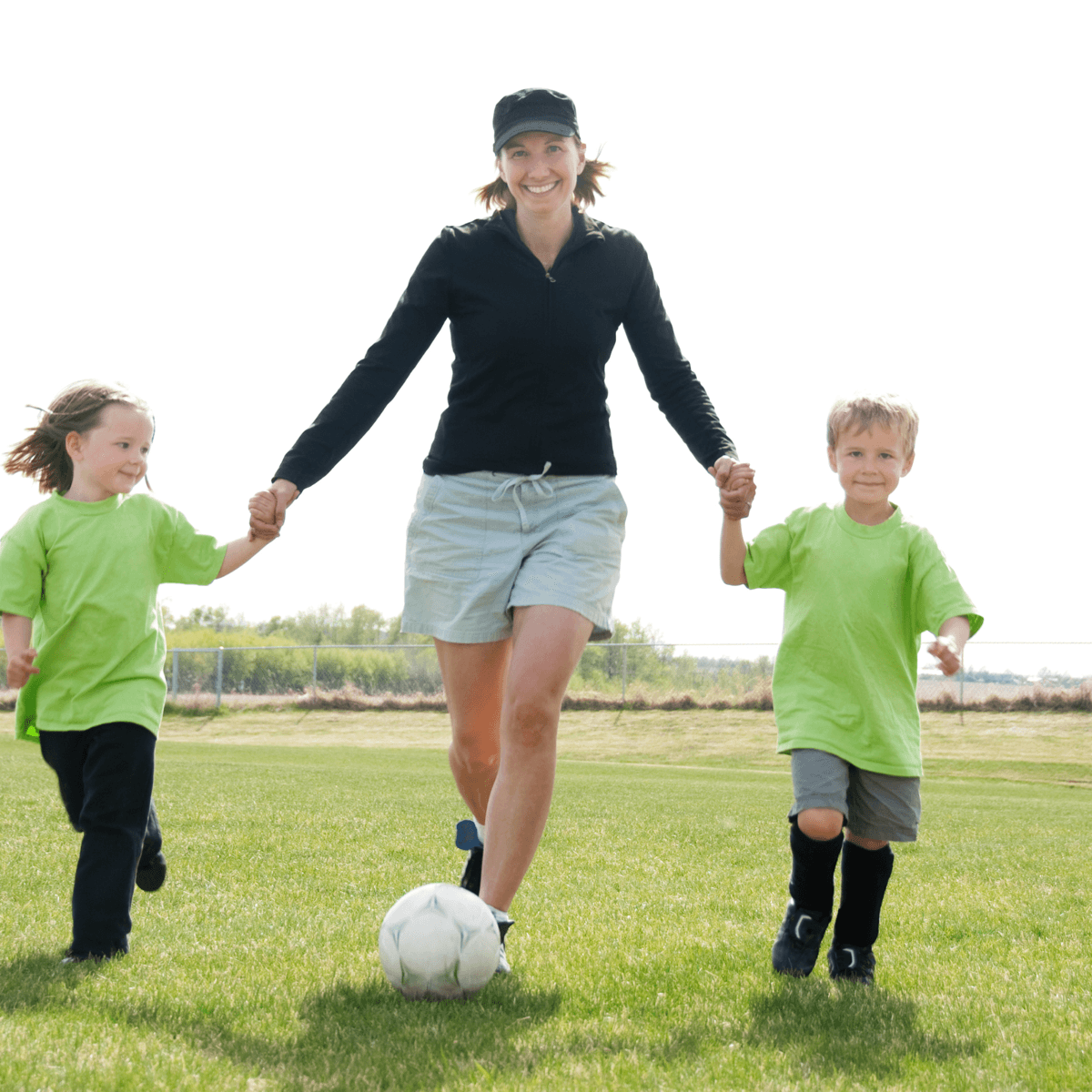 Woman playing soccer with her kids, staying active through menopause
